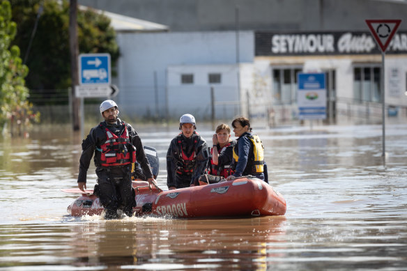 Police officers rescue residents from the flooding in Seymour last Friday.