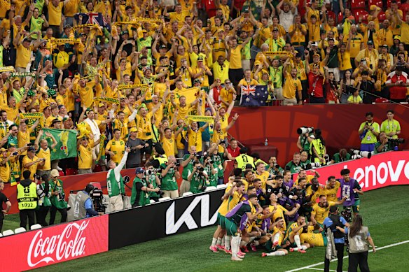 The Socceroos and their fans celebrate a perfect opening-round win.