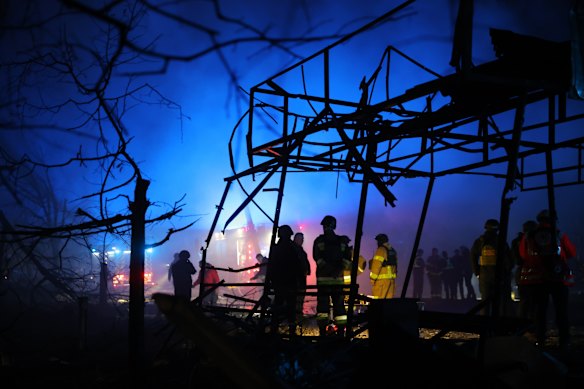Rescuers work at a market destroyed by a Russian airstrike in Zaporizhzhia, Ukraine, on November 21.