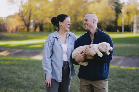 Emma and David Pocock, pictured with their dog Bronte, are expecting a baby.