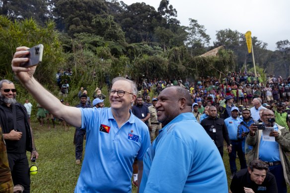 Prime ministers Anthony Albanese and James Marape take a selfie after the Anzac Day dawn service at the Isurava memorial site on the Kokoda Track in PNG.