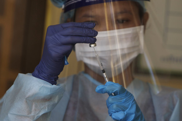 A health worker prepares a dose of the Sinovac’s COVID-19 vaccine. 