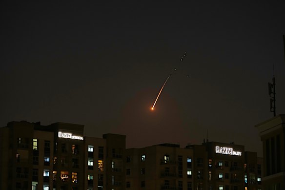 The flare of a projectile is seen over the skyline of Dubai on February 28.