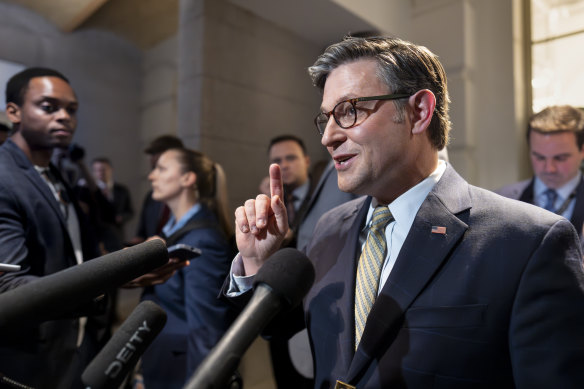 Speaker of the House Mike Johnson emerges from a closed-door meeting with fellow Republicans at the Capitol in Washington.