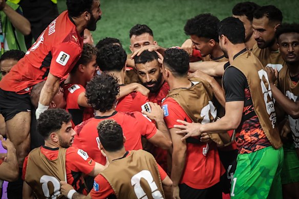 Salah is mobbed by teammates after scoring in Egypt’s 3-1 win over New Zealand.