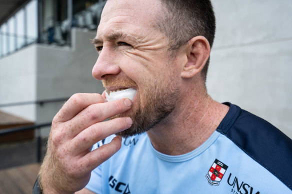 Waratahs player Jed Holloway with the smart mouthguard used to detect potential concussions. 