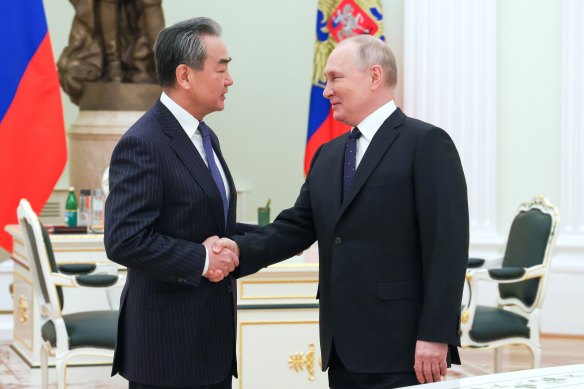 Russian President Vladimir Putin greets Chinese Communist Party’s foreign policy chief Wang Yi.