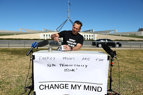 Senator Matt Canavan recreates a meme outside Parliament House as the economic roundtable takes place inside Parliament House.