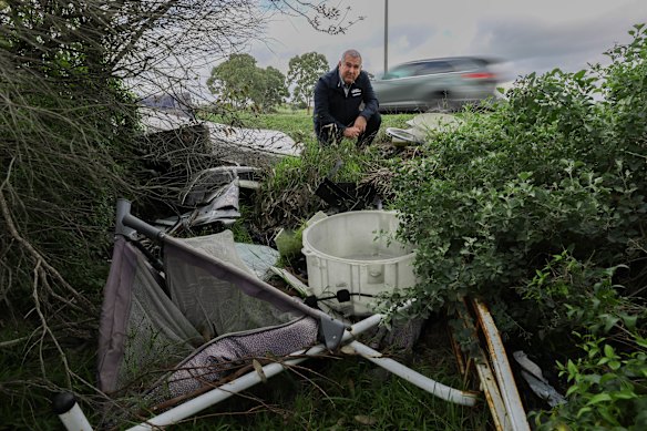 Whittlesea Mayor Lawrie Cox inspects rubbish on the side of the road at Craigieburn Road, East Wollert. Whittlesea Council is calling on the Department of Transport to take action, as state-owned roads in the area face widespread maintenance issues.