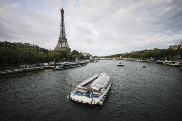 Barges cruise on the Seine River near the Eiffel Tower during a rehearsal for the Paris 2024 Olympic Games. 
