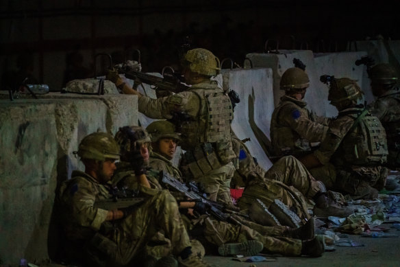 British soldiers secure the perimeter outside the Baron Hotel, near the Abbey Gate, in Kabul, Afghanistan.