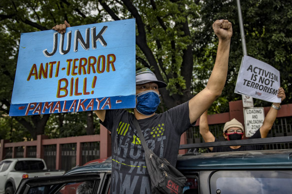 People protest against the anti-terror bill outside the Philippine Congress, despite a ban on public gatherings due to the coronavirus outbreak.