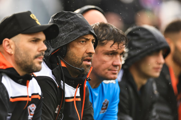 Wests Tigers coach Benji Marshall (second from left) on the bench in Tamworth.