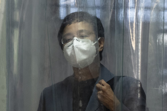 Maria Ressa, editor and CEO of Rappler, passes through a disinfection chamber as she arrives in court in Manila on Monday.