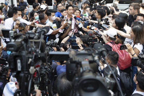 Leader of Move Forward Party Pita Limjaroenrat, rear centre, talks to media after casting his vote during a general election at a polling station in Bangkok.