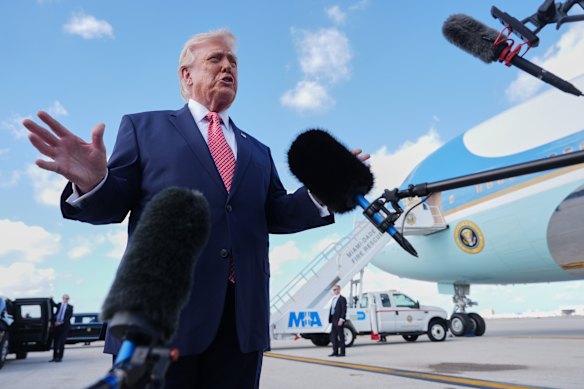 President Donald Trump speaks to reporters after stepping off Air Force One on Friday.