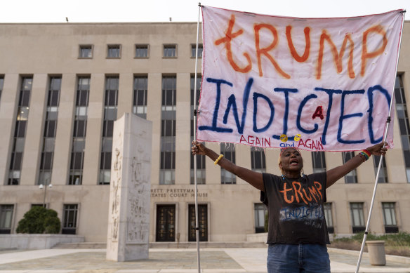 Nadine Seiler protests as she holds a banner outside federal court in April last year.