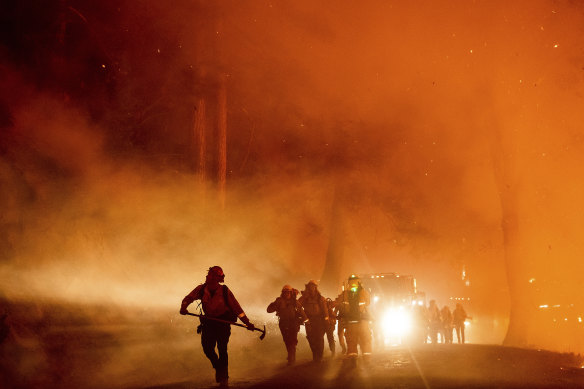 Firefighters battle the Mosquito Fire burning in Placer County, California.