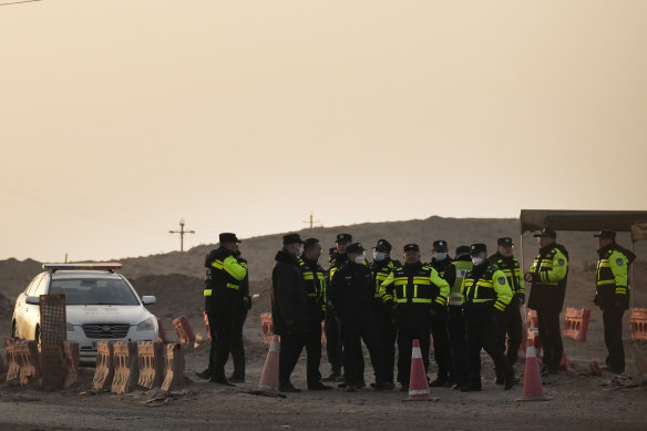 Police officers gather at a checkpoint along a road in Qingtongxia.