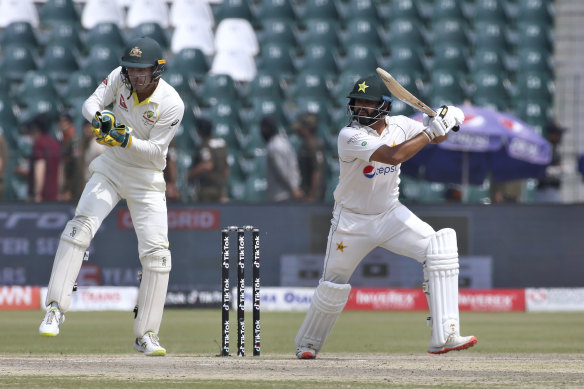Pakistan’s Azhar Ali, right, plays a shot while Australia’s Alex Carey watches.