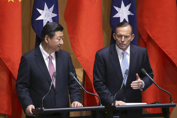 China’s President Xi Jinping, left, and former Australian Prime Minister Tony Abbott speak at a press conference in 2014. 