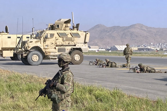 US soldiers stand guard at the international airport in Kabul last week.