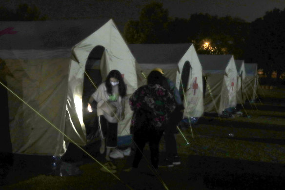 People evacuated from their homes are accommodated in the tent area of the shelter after the main earthquake in Hualien City, eastern Taiwan.