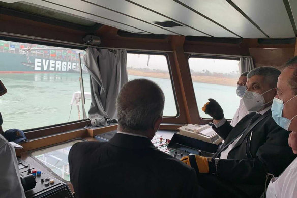 Head of the Suez Canal Authority Ossama Rabei, second right, assesses the stuck ship.