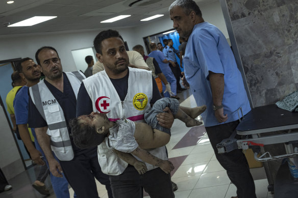 A child wounded in Israeli military strikes is brought to Shifa hospital.