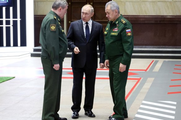 Russian President Vladimir Putin, centre, speaks with Chief of the General Staff General Valery Gerasimov, left, and Russian Defence Minister Sergei Shoigu, after a meeting with senior military officers in Moscow.