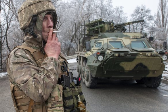 A Ukrainian soldier takes a break while on patrol outside Kharkiv.
