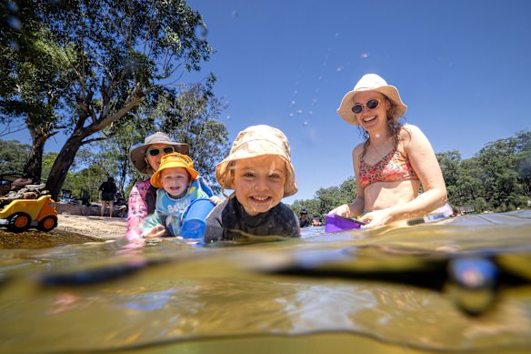 Kristin and her son Theoden, 3, and Maddie and her son Luca, 3, cool off at Lake Parramatta on Thursday.