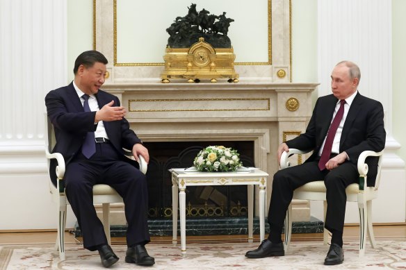 Chinese President Xi Jinping speaks to Russian President Vladimir Putin at the Kremlin on Monday.