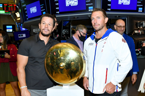 F45 founder Adam Gilchrist (right) and shareholder Mark Wahlberg on the floor of the New York Stock Exchange in 2021.