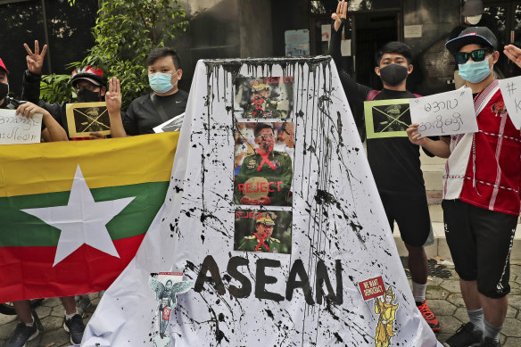 Activists display posters and defaced portraits of Myanmar’s Commander-in-Chief Senior General Min Aung Hlaing in Jakarta in April.