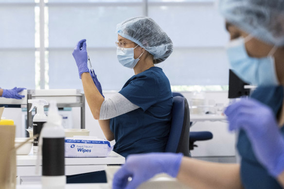 Pharmacists prepare the Pfizer vaccine at the Sydney Olympic Park mass vaccination clinic.