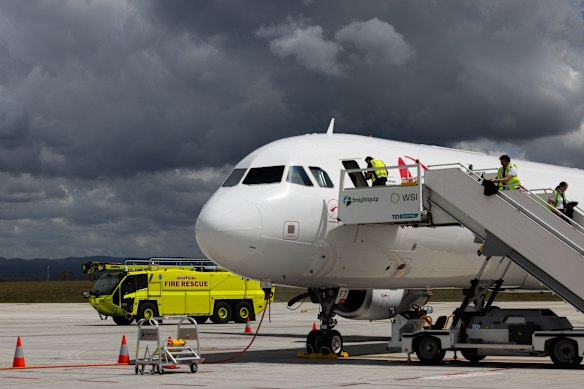 A new fire truck drives past the refitted A321 aircraft at Western Sydney Airport’s cargo hub.