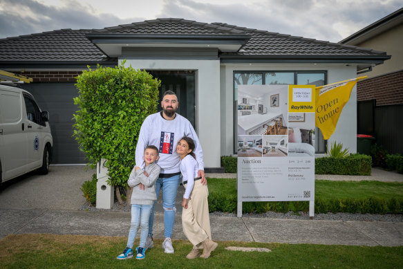 Matt Karacan  and his daughter Eva and son Ali outside the Craigieburn home that is going to auction this weekend. Matt and his wife Abbey are selling up to move to Greenvale.