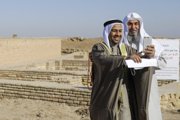 People take selfies next to what is believed to be the house of Abraham near the Great Ziggurat in the archaeological area of Ur, 20 kilometres south-west of Nasiriyah, Iraq, on Saturday, March 6, 2021 before the arrival of Pope Francis. 