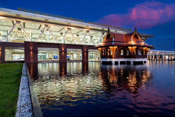 An outdoor reflecting pool features Thai temple-inspired features.