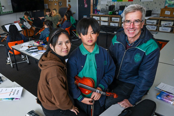 From left: Linh Nguyen with her son Kaien Vu  and Sacred Heart School, principal Matthew Shawcross.