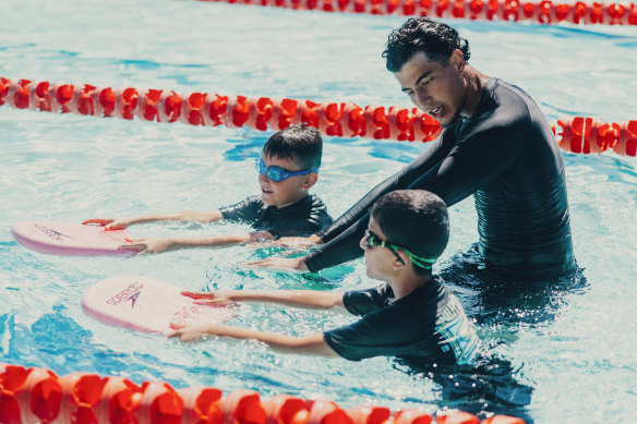 Swim Brothers instructor Omar Affouf with Gazan refugees Adam Murad and Mohammed Al-Bashiti during a free lesson. 
