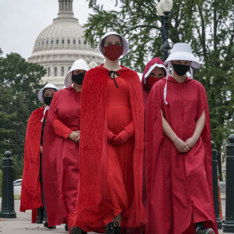 Activists opposed to the confirmation of Judge Amy Coney Barrett are dressed as characters from The Handmaid's Tale, a dystopian story in which women are denied reproductive rights, at the Supreme Court in Washington on October 11, 2020.