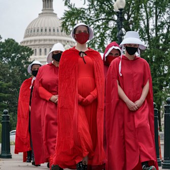 Activists opposed to the confirmation of Judge Amy Coney Barrett are dressed as characters from The Handmaid's Tale, a dystopian story in which women are denied reproductive rights, at the Supreme Court in Washington on October 11, 2020.