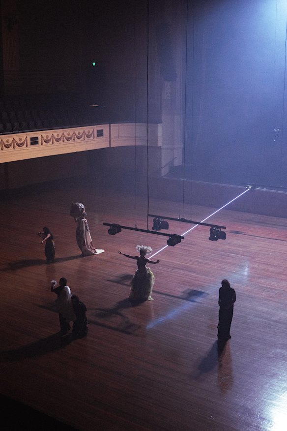 The precision of the lasers contrasts strongly with purposelessness of the dancers.