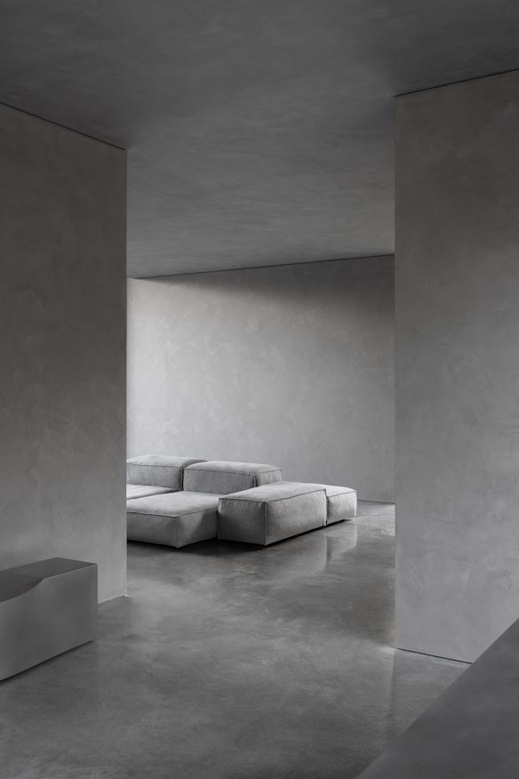 An armchair located at the end of a wing in front of a large picture window suggests a main bedroom and ensuite beyond.