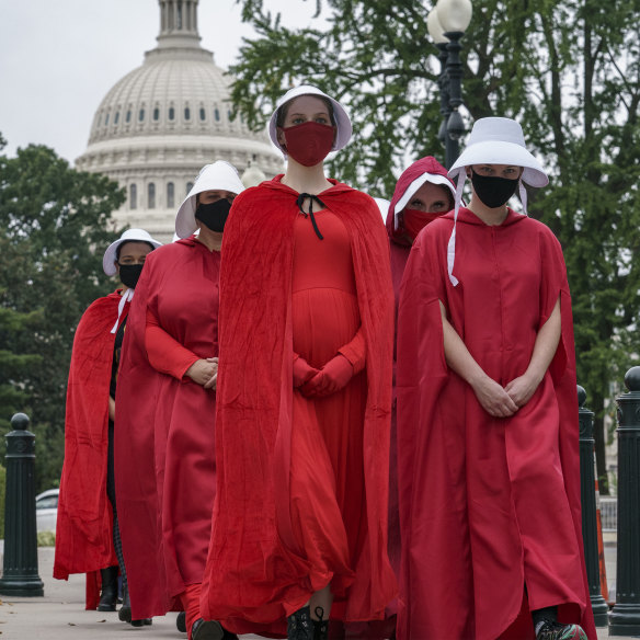 Activists opposed to the confirmation of Judge Amy Coney Barrett are dressed as characters from The Handmaid's Tale, a dystopian story in which women are denied reproductive rights, at the Supreme Court in Washington on October 11, 2020.