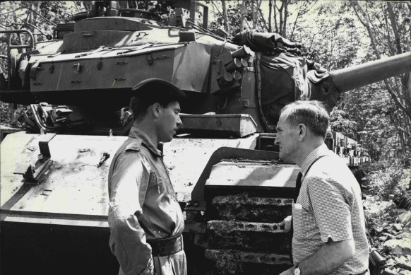 As secretary of the NSW Liberal Party, John Carrick, discusses the important role played by tanks in the 1st Australian Task Force area, South Vietnam, with Captain Bernard Sullivan in 1968.