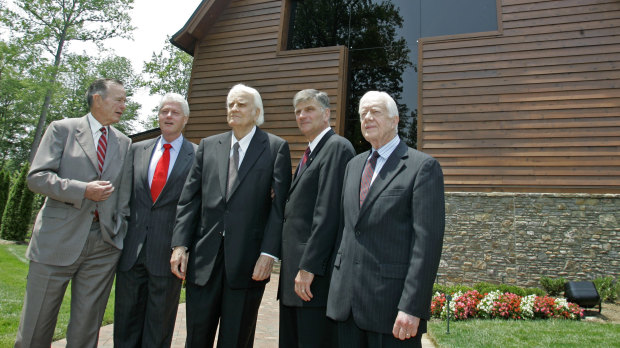 Former presidents George H.W. Bush, Bill Clinton and Jimmy Carter (right) join Franklin Graham (second right) and his father Billy Graham in front of the Billy Graham Library in 2007.