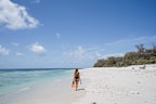 Snorkeller walking along the beach